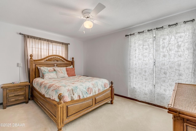 bedroom with light carpet and ceiling fan