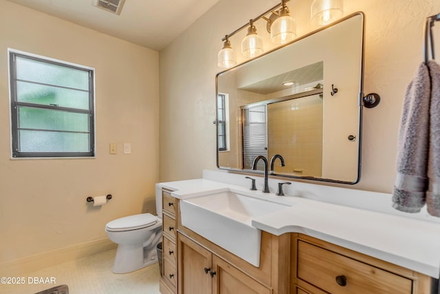 bathroom with vanity, toilet, and walk in shower