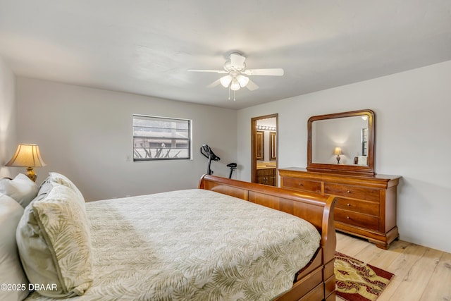 bedroom featuring ensuite bathroom, light hardwood / wood-style flooring, and ceiling fan