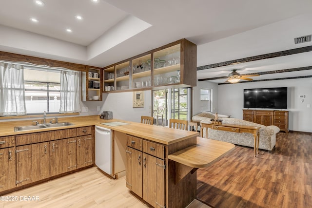 kitchen with beam ceiling, ceiling fan, dishwasher, sink, and light hardwood / wood-style floors