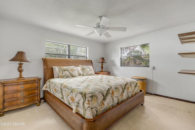 bedroom with ceiling fan and light carpet