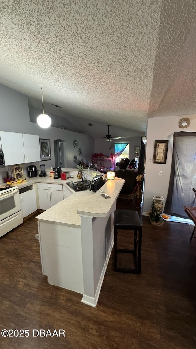 kitchen with white cabinetry, light countertops, white gas range, dark wood-style floors, and ceiling fan