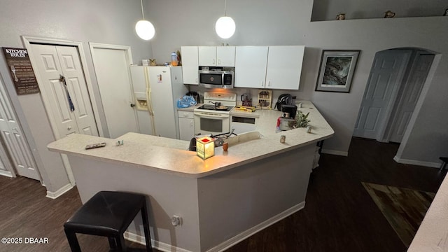 kitchen featuring white cabinetry, light countertops, a peninsula, and white appliances