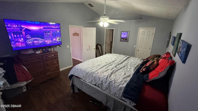 bedroom with visible vents, wood finished floors, lofted ceiling, and a ceiling fan