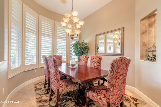 tiled dining space with a chandelier