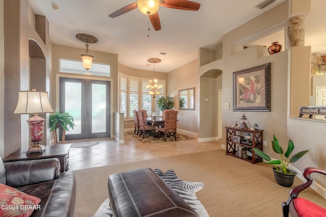 interior space featuring french doors and ceiling fan with notable chandelier