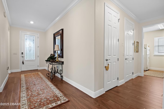 foyer entrance with dark hardwood / wood-style floors and ornamental molding