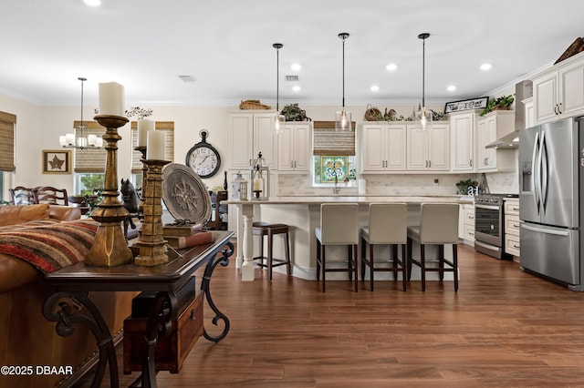 kitchen featuring stainless steel appliances, hanging light fixtures, and a center island