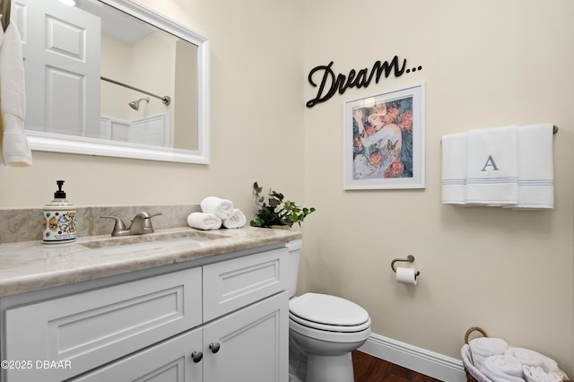 bathroom featuring toilet, vanity, wood-type flooring, and walk in shower