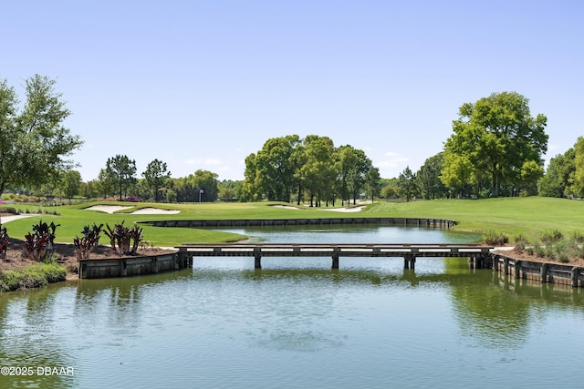 view of dock featuring a water view and a lawn