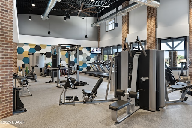 gym with a towering ceiling