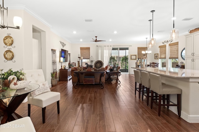 interior space with ceiling fan, dark hardwood / wood-style flooring, and crown molding