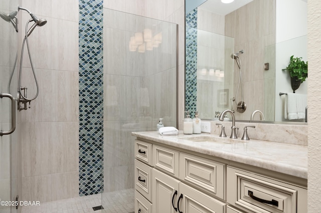 bathroom featuring vanity and a shower with door