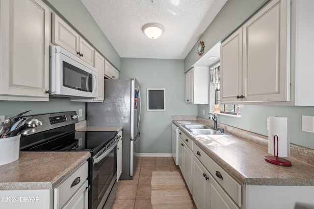 kitchen with light tile patterned flooring, sink, a textured ceiling, stainless steel electric stove, and white cabinets