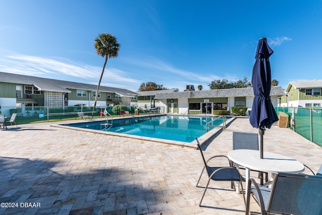 view of swimming pool with a patio area