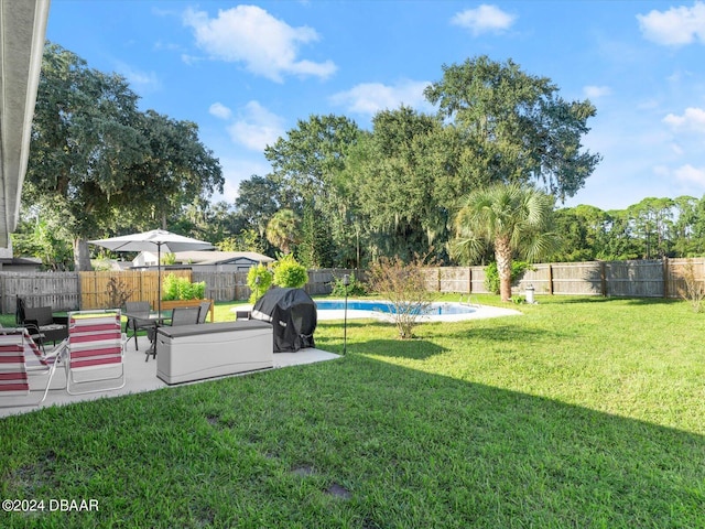 view of yard featuring a fenced in pool, a patio, and a fenced backyard