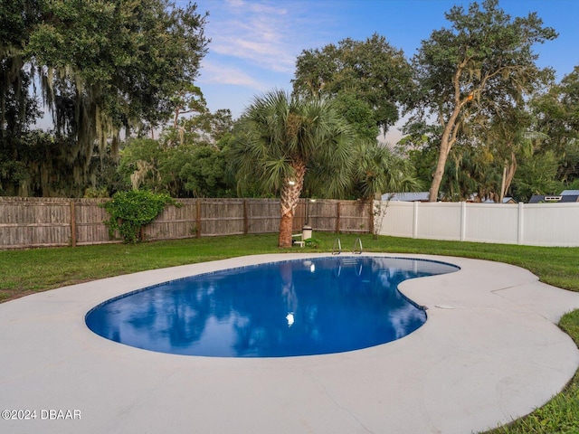 view of pool featuring a yard, a fenced backyard, and a fenced in pool