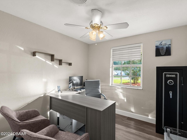 office space with a ceiling fan, wood finished floors, and baseboards