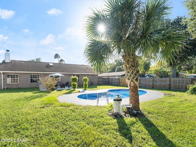 view of pool featuring a lawn, a fenced in pool, and a fenced backyard