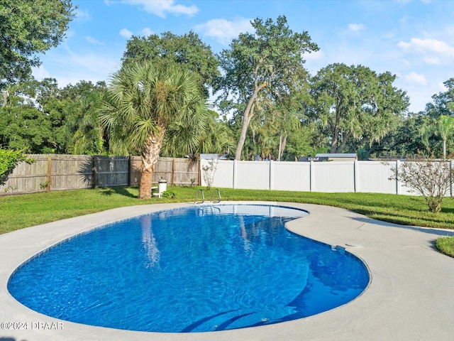 view of pool with a fenced backyard, a fenced in pool, and a yard