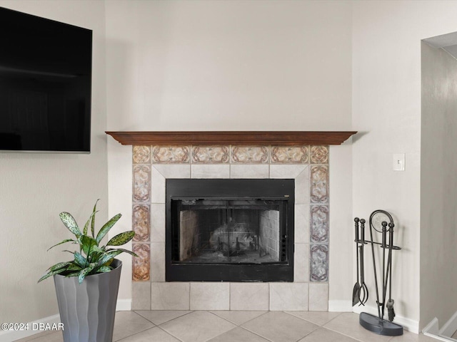 room details with baseboards and a tiled fireplace