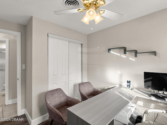 tiled home office with a ceiling fan, visible vents, and baseboards