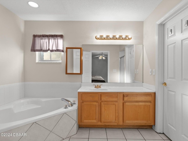 ensuite bathroom featuring vanity, a garden tub, ensuite bathroom, and a textured ceiling