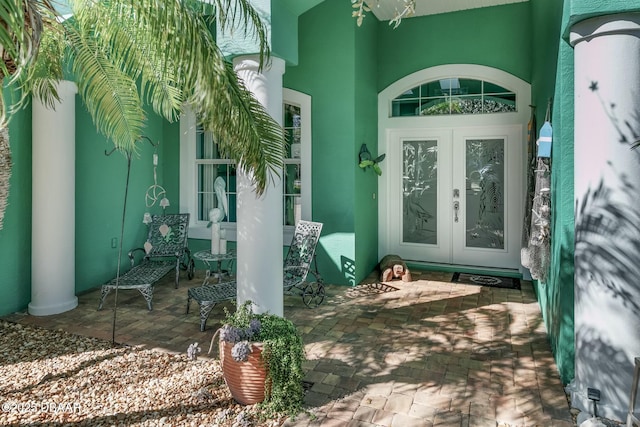 view of exterior entry featuring french doors and a patio