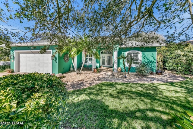 exterior space with french doors and a garage