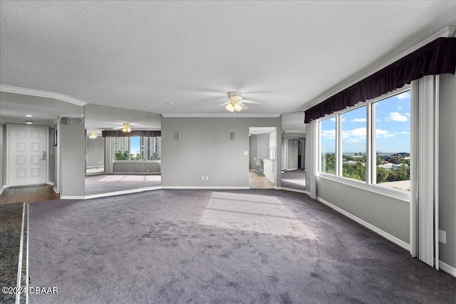 unfurnished living room featuring ceiling fan, a textured ceiling, dark colored carpet, and ornamental molding