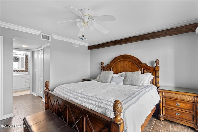 bedroom featuring hardwood / wood-style flooring, ensuite bath, ceiling fan, and crown molding