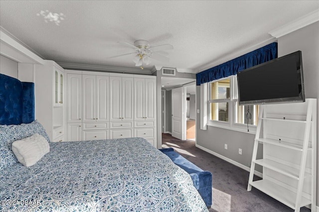 bedroom featuring dark colored carpet, ornamental molding, ceiling fan, a textured ceiling, and a closet