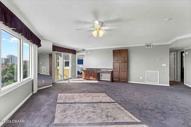 unfurnished living room featuring ceiling fan, dark colored carpet, a textured ceiling, and ornamental molding