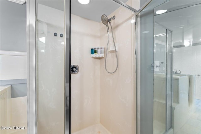 bathroom featuring a shower with shower door