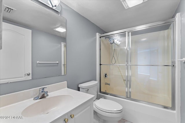 full bathroom with toilet, vanity, and shower / bath combination with glass door