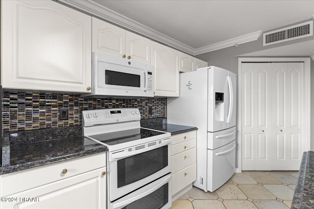 kitchen with ornamental molding, dark stone counters, decorative backsplash, white cabinets, and white appliances