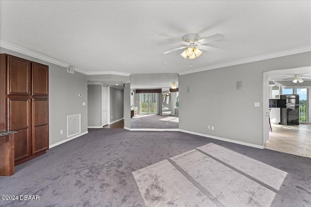 unfurnished living room with ceiling fan, a textured ceiling, dark carpet, and ornamental molding