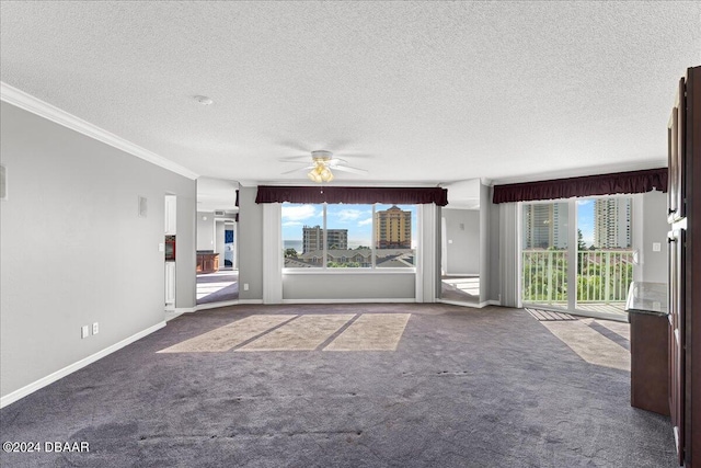 unfurnished living room with a textured ceiling, carpet floors, ceiling fan, and crown molding