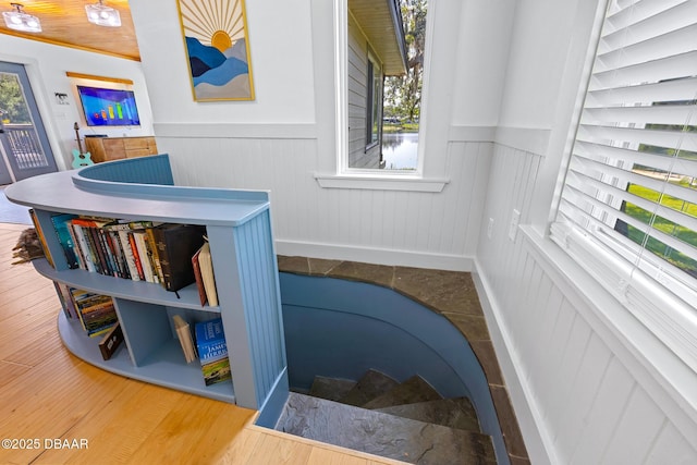 2300 Lake Ruby Rd, Deland, FL 32724 - staircase featuring a wainscoted wall, healthy amount of natural light, and wood finished floors