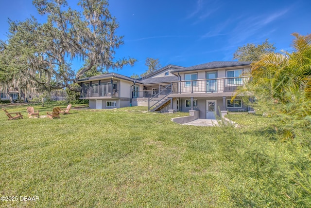 2300 Lake Ruby Rd, Deland, FL 32724 - rear view of property with stairway, a yard, a wooden deck, and stucco siding