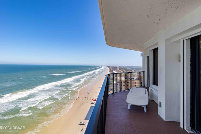 balcony with a beach view and a water view