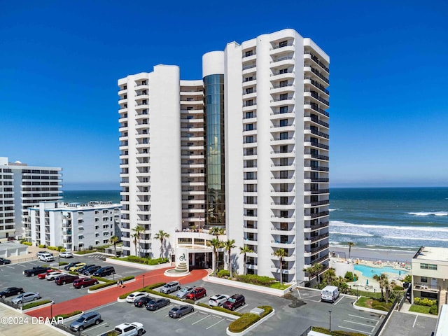 view of building exterior with a view of the beach and a water view