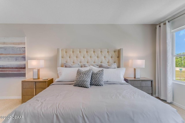 bedroom featuring light carpet