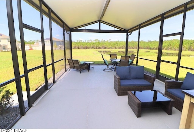 sunroom featuring vaulted ceiling