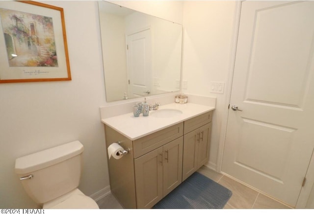 bathroom featuring tile patterned flooring, vanity, and toilet