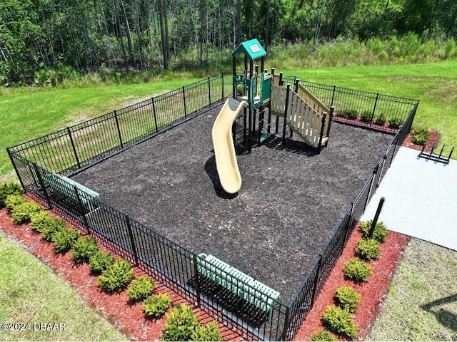 view of jungle gym with a lawn