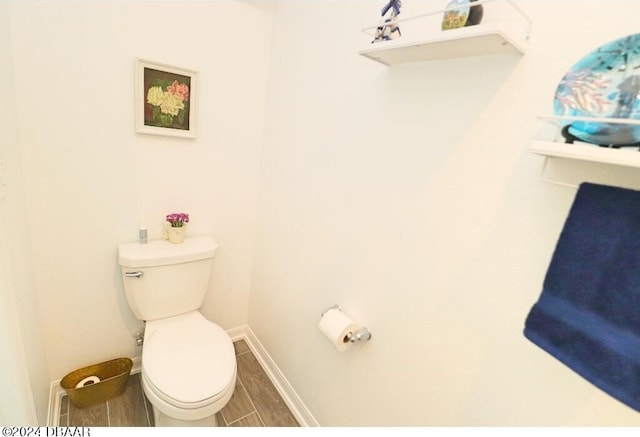 bathroom featuring hardwood / wood-style flooring and toilet