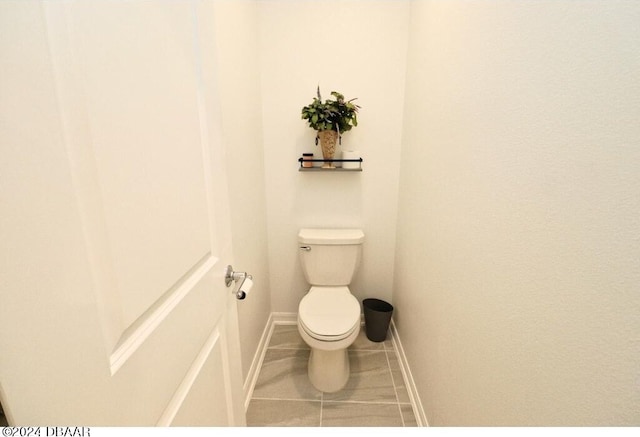 bathroom featuring tile patterned flooring and toilet