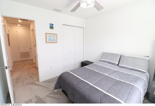 carpeted bedroom featuring ceiling fan and a closet