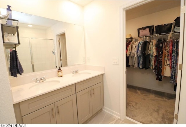 bathroom featuring a shower with door and vanity